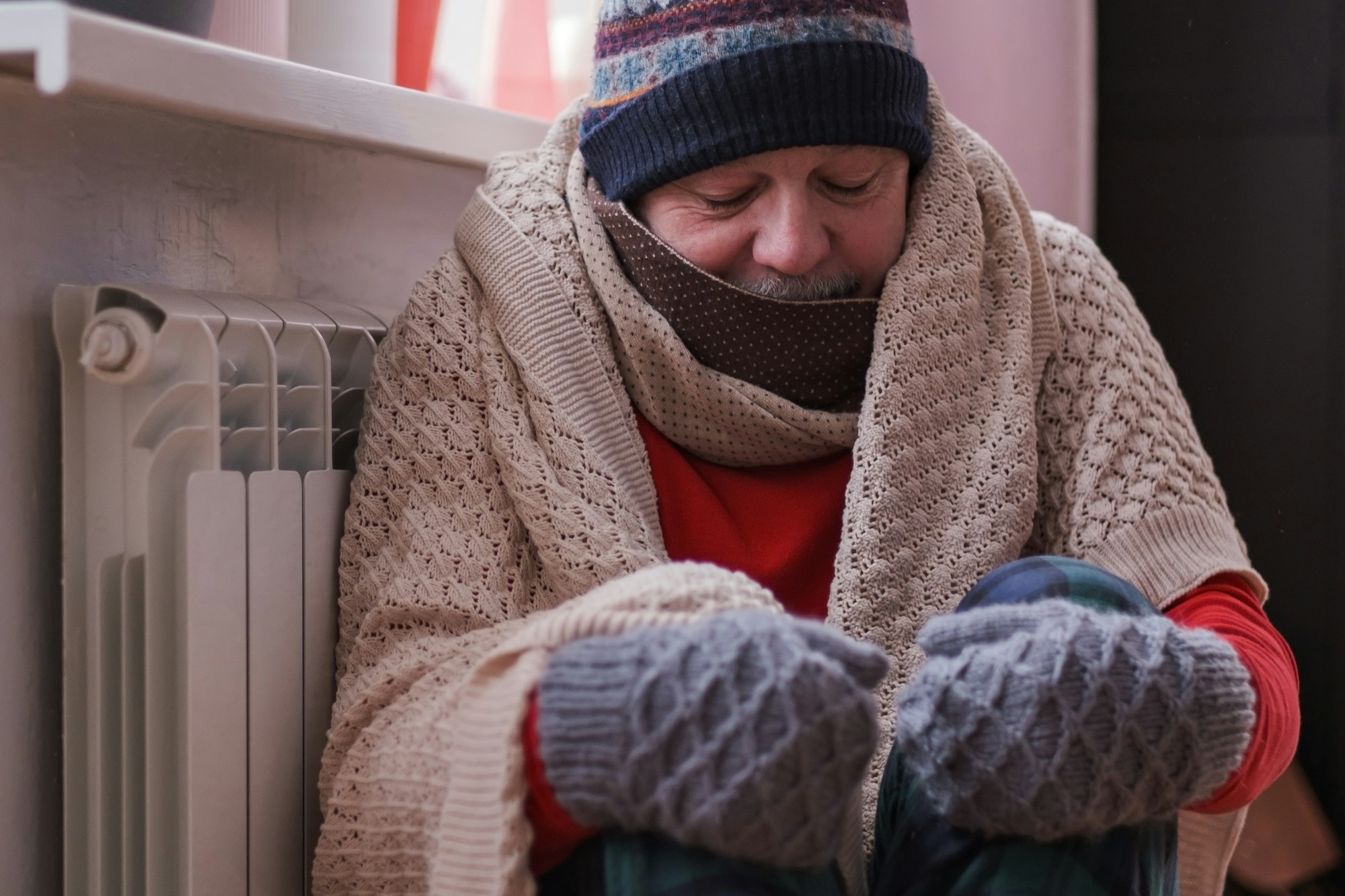 Man feeling cold at home having problems with home heating. No money for paying service